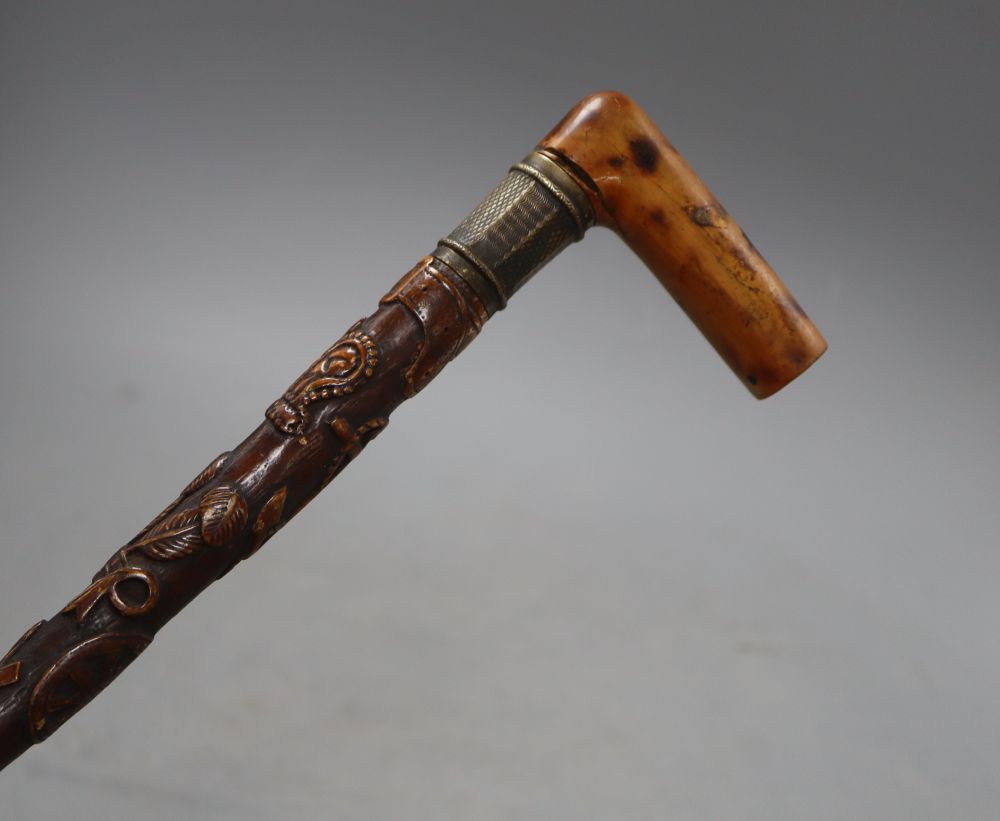 A Victorian walking stick, carved with a crown, an anchor and oak leaves, length 85cm